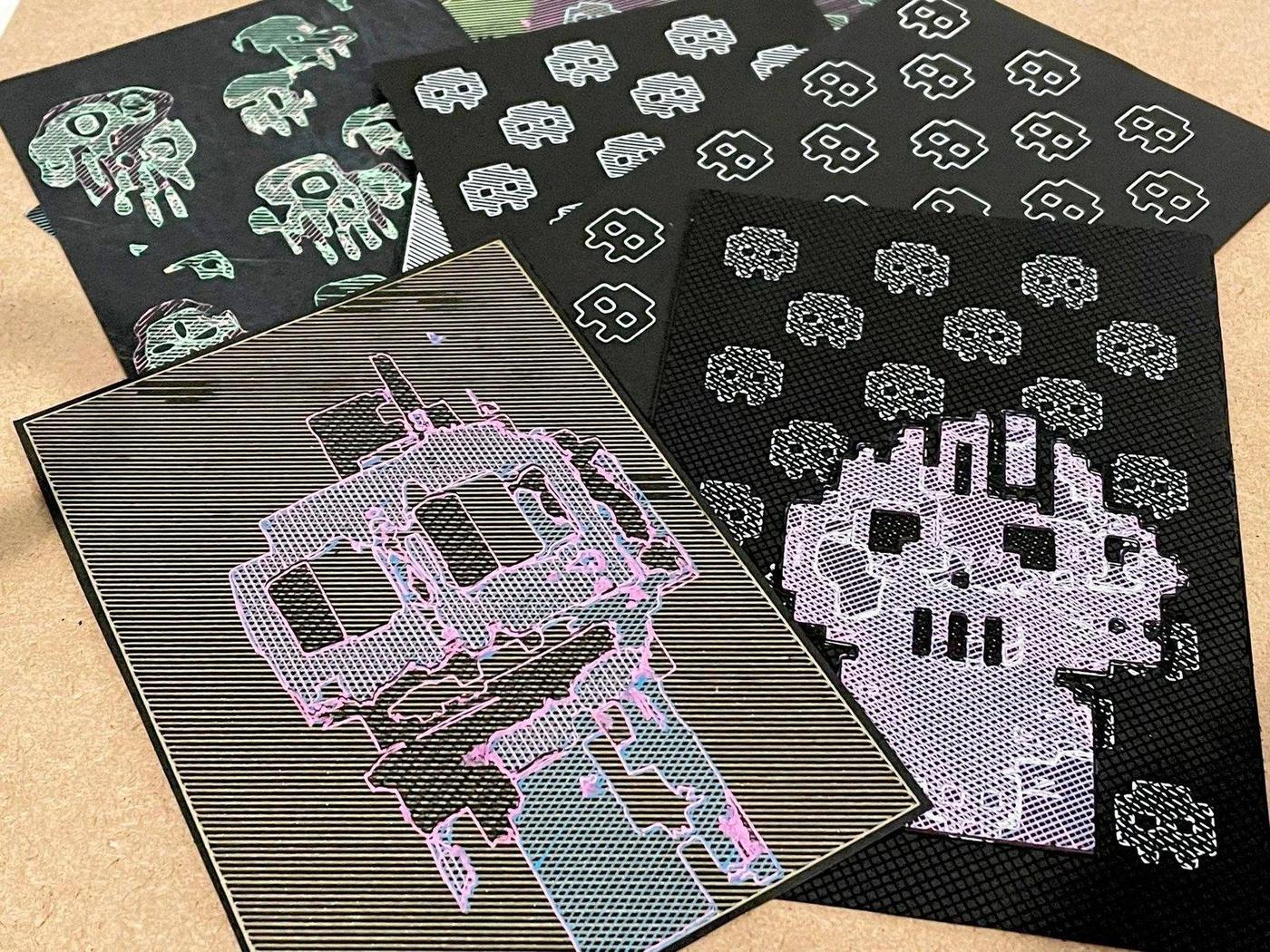 Robot-drawn byteGANs on black postcard stock