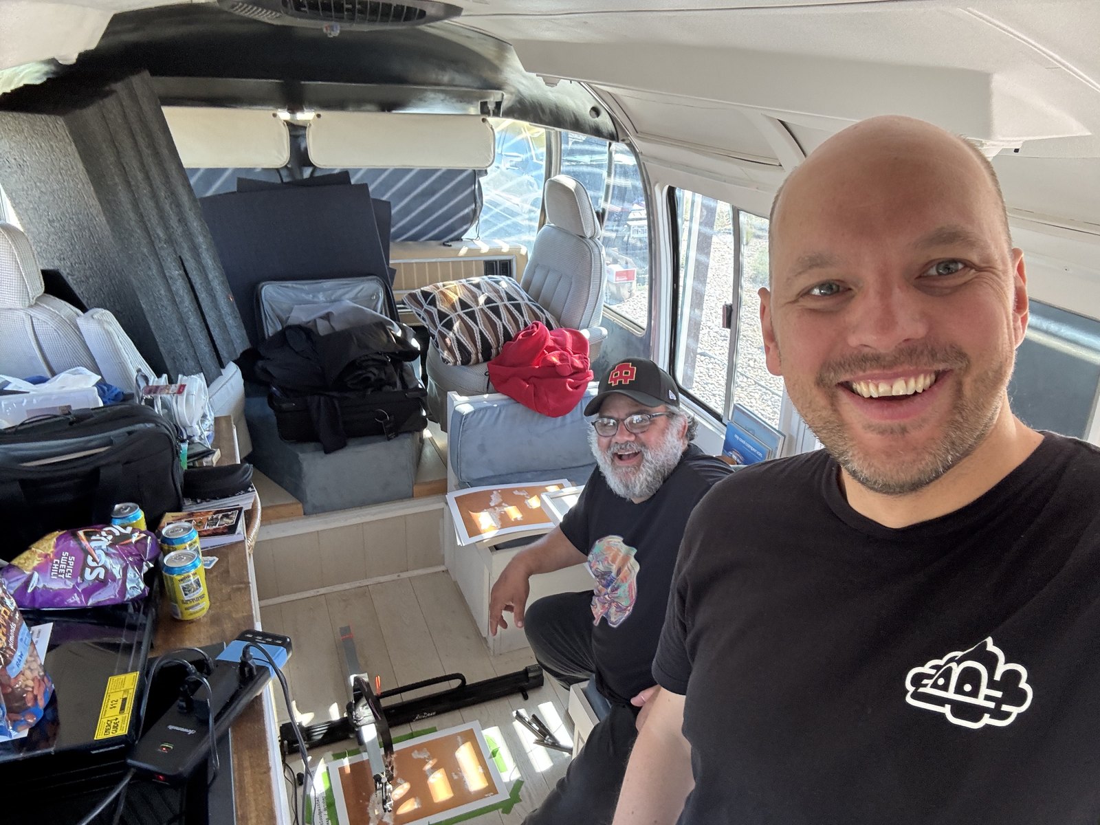 Ostachowski and Van Arman inside the camper with stacks of prints